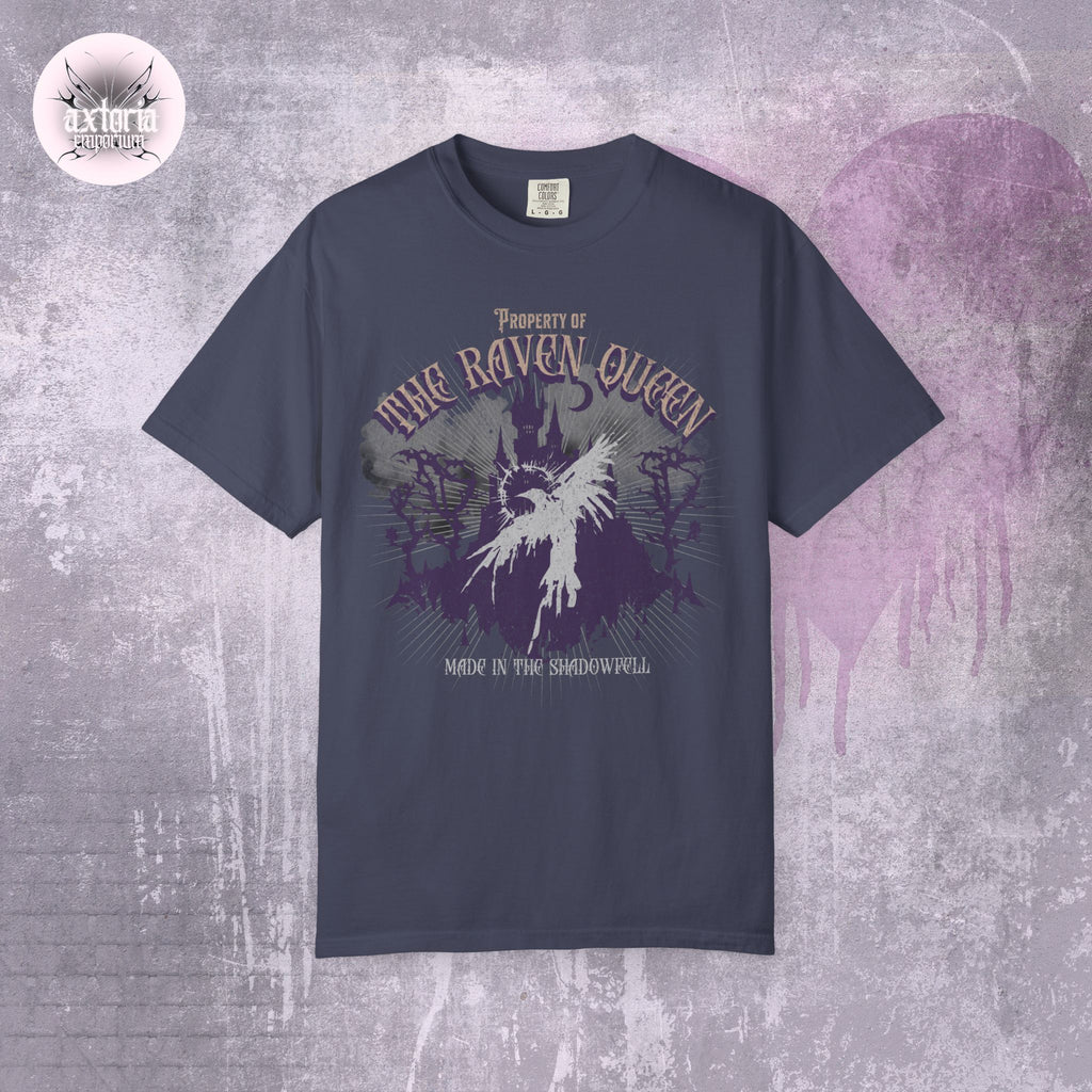 Navy blue Dungeons and Dragons t-shirt with 'Property of the Raven Queen Made in the Shadowwell' design on a textured gray background.